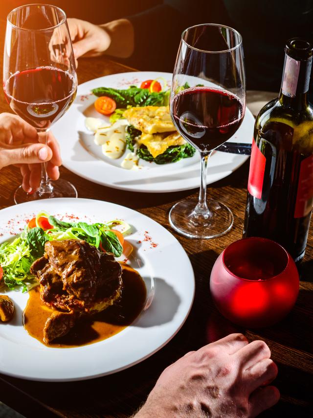 Couple having romantic dinner in a restaurant in rays of the sun